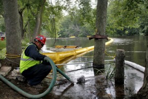 Suction hose cleans oil from the Kalamazoo River - courtesy Kalamazoo Gazette